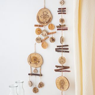 Mobile made of wooden discs with fire painting